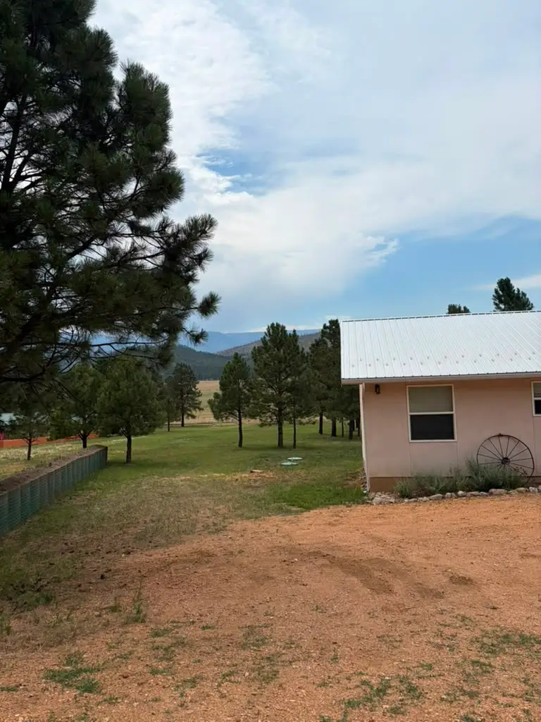 A well-maintained property with healthy trees and mountain views in Las Vegas, NM after a Timberline Tree Service job